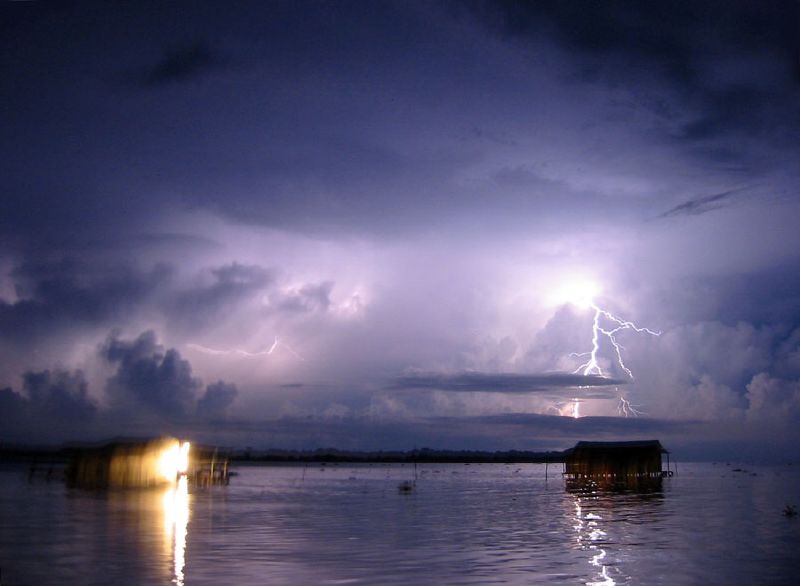 Lightning over a lake at night.