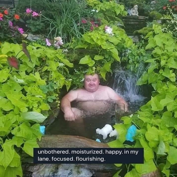 Fat gentleman sitting in a small pool surrounded by vines.