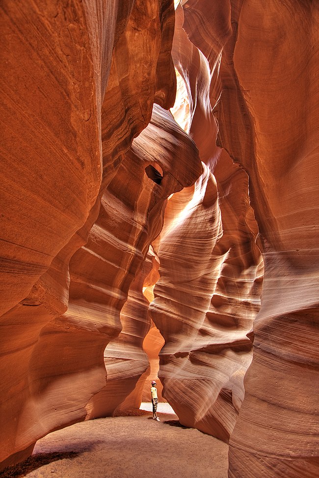 Tall, narrow canyon of eroded red rocks.